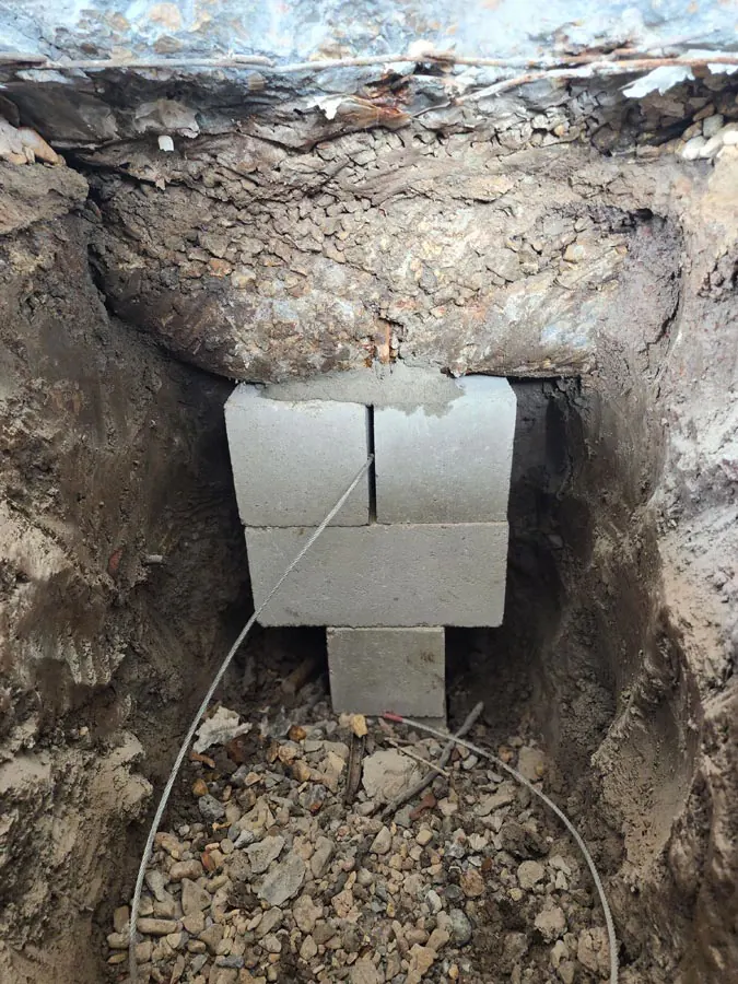 Concrete support blocks inside a foundation access hole